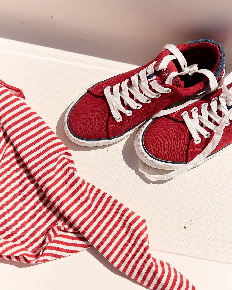 Detail shot of red sneakers and striped fabric